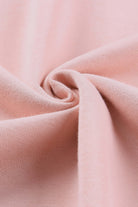 Close-up of soft pink fabric showcasing gentle texture of BASHFUL BEAUTY sweatshirt from Vivian-Lu.