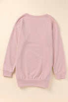 Back view of BASHFUL BEAUTY cozy pink sweatshirt with long sleeves and loose fit, perfect for casual wear.