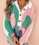 Color block top with buttoned neckline, featuring pink, green, and white panels, worn with denim jeans.