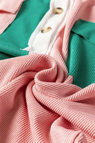 Close-up of BOLD BOUNDARIES TOP by Vivian-Lu with buttoned neckline and color block pattern in pink, green, and white fabric.