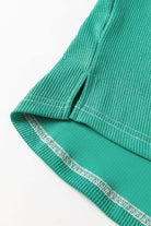 Green ribbed fabric detail of Bold Boundaries Top by Vivian-Lu, showcasing quality stitching and durable polyester-elastane blend.