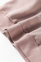 Close-up of INNER PEACE sweatshirt fabric and cuff detail in soft pink, featuring a cozy, stylish design made of polyester and cotton blend.