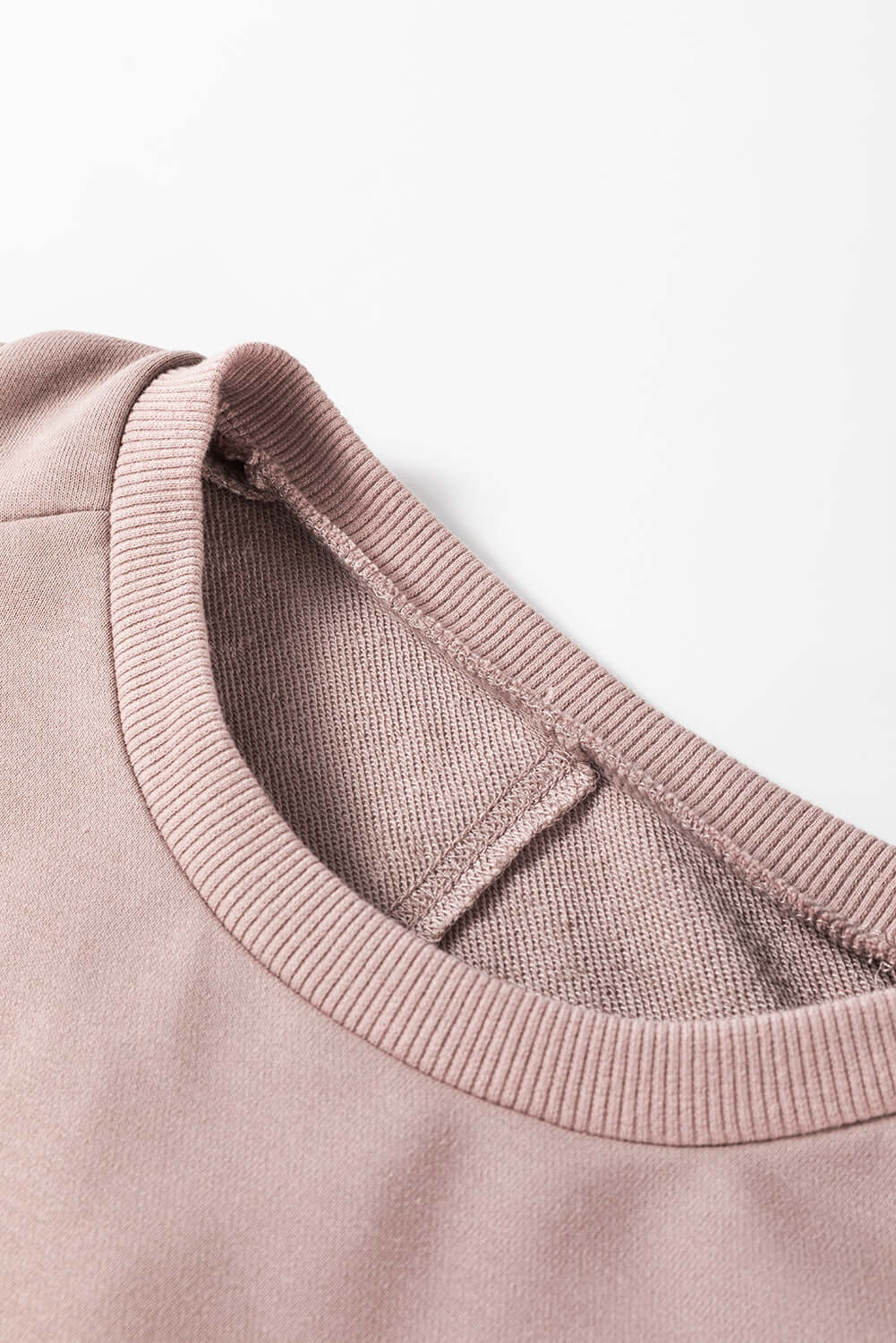 Close-up of neckline and stitching on a cozy INNER PEACE sweatshirt made from polyester and cotton blend, featuring ribbed design.