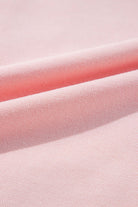 Close-up of light pink fabric texture from PUT A BOW ON IT Top by Vivian-Lu, highlighting soft material and ribbed design.