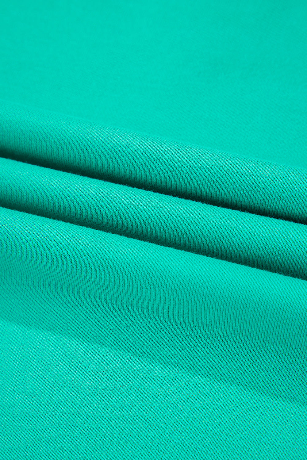 Teal fabric texture close-up of the Teal We Meet Again Crewneck sweatshirt, showcasing its sleek and structured material.