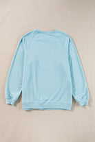 Sky blue crew neck pullover with rainbow color-block and stripes, shown from the back on a neutral background.