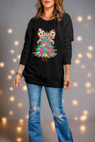 Festive sweatshirt with colorful Christmas tree and animal-print bow design, worn with jeans, ideal for holiday celebrations.