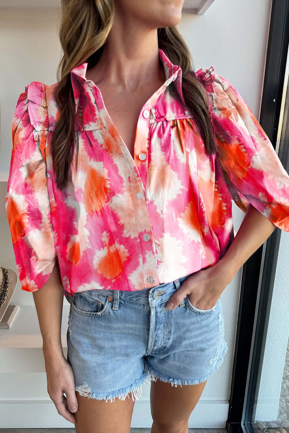 BLENDED BEAUTY TOP - Trendy, Stylish Blouse by Vivian-Lu $36.00 Discover the BLENDED BEAUTY TOP, a chic blouse with a pink abstract pattern, frilled ruffles, and half sleeves. Perfect for comfort and style from our boutique. Teal Tiger Boutique