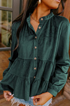 Woman wearing State of Grace forest green top with ruffle tiers and button-up design