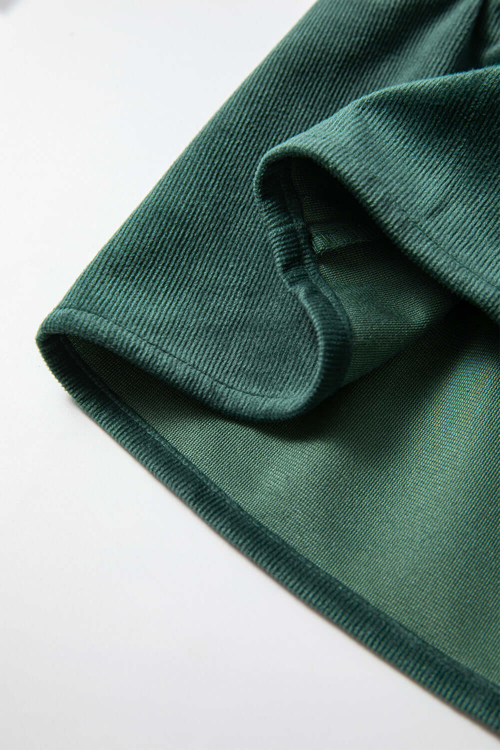 Close-up of State of Grace forest green top fabric showing delicate texture and luxurious material by Vivian-Lu.