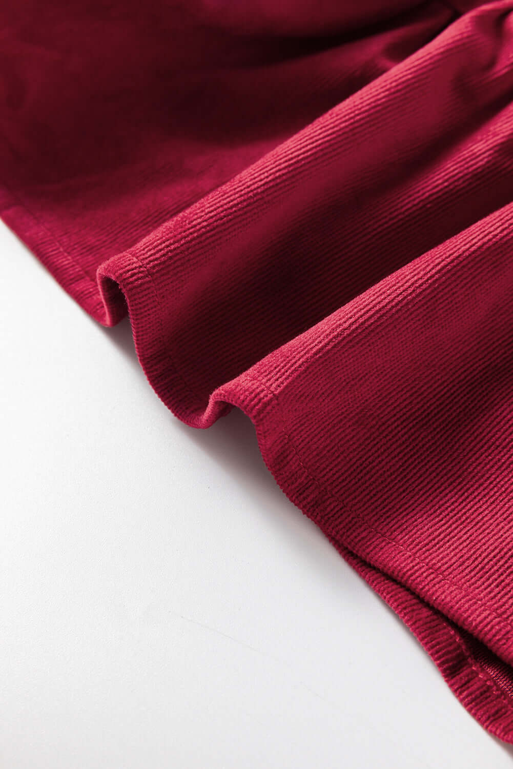 Burgundy ruffle tiered fabric detail from State of Grace top by Vivian-Lu, showcasing its luxurious texture and rich color.