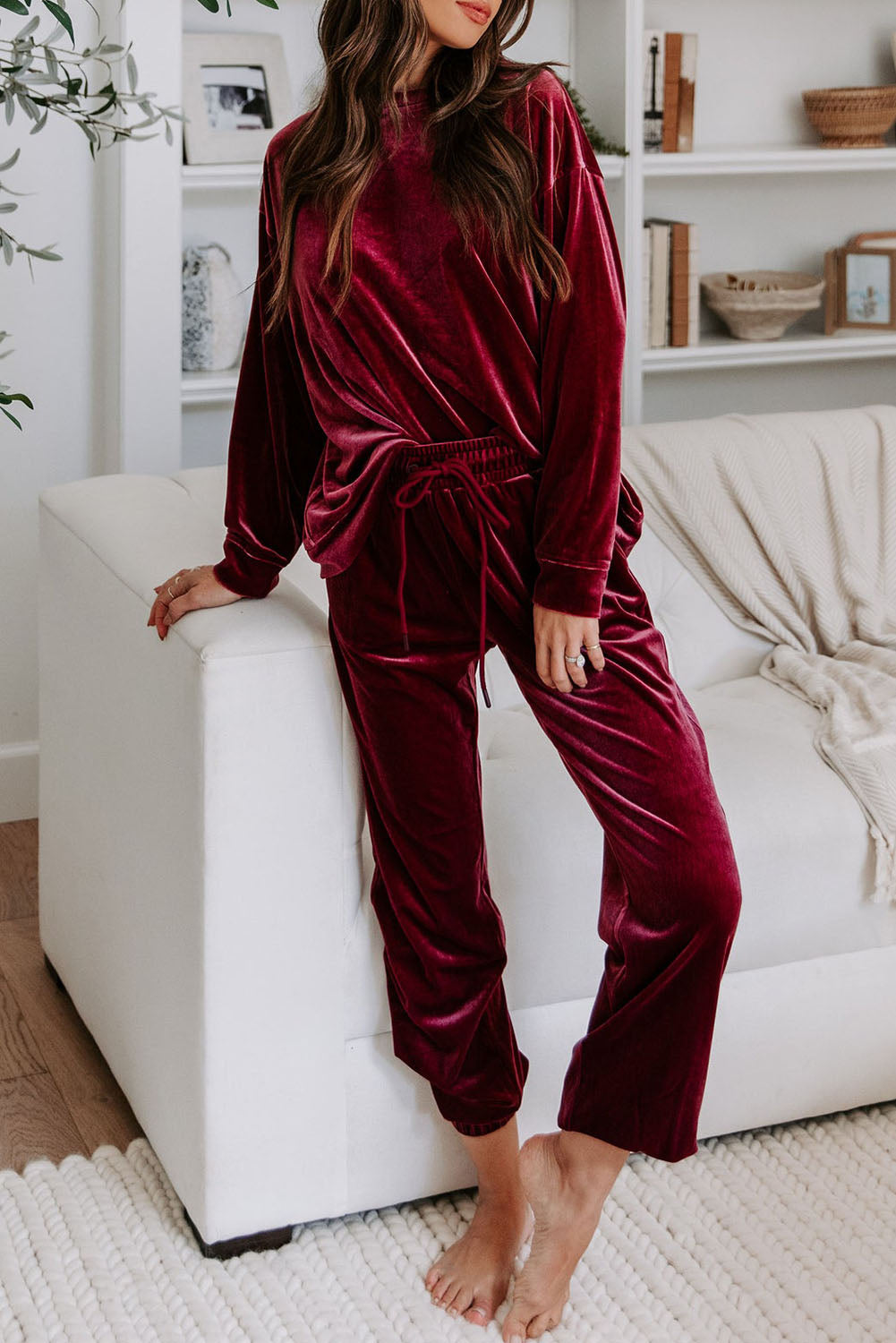 Woman wearing Velvet Wine two-piece set in burgundy with long sleeves and drawstring pants for a stylish and comfortable look.