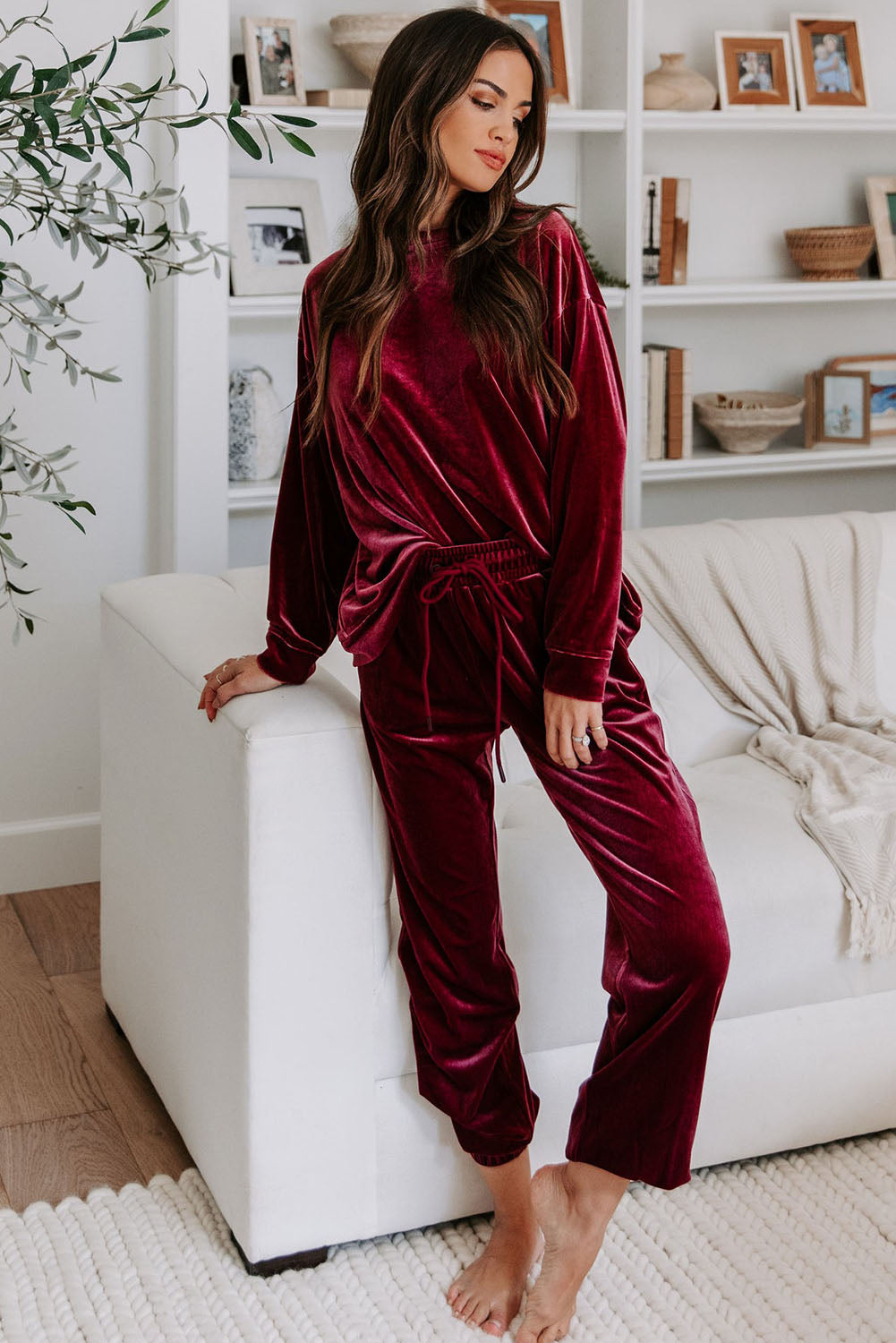 Woman wearing a Velvet Wine set with long sleeves and drawstring pants, showcasing stylish comfort in burgundy wine color.