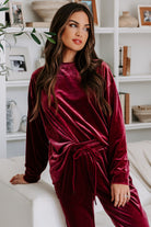 Woman wearing Velvet Wine set with long sleeve top and drawstring pants in burgundy, exuding comfort and style.