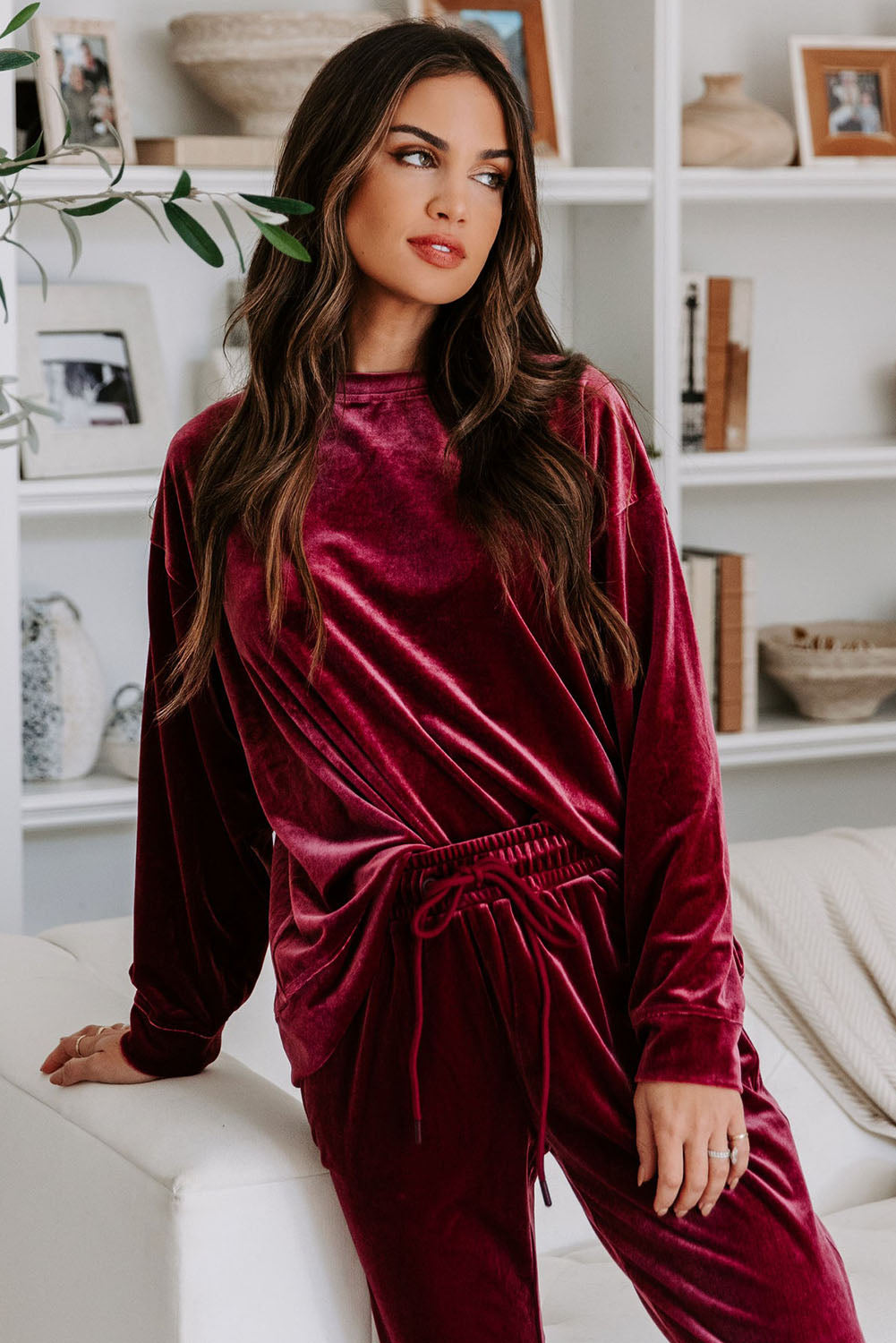 Woman wearing Velvet Wine 2-piece set with long sleeve top and drawstring pants in burgundy color, exuding comfort and style.