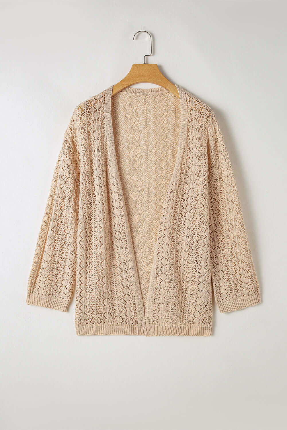 Apricot beige cable knit cardigan with hollow-out details, perfect for layering and cozy outfits.