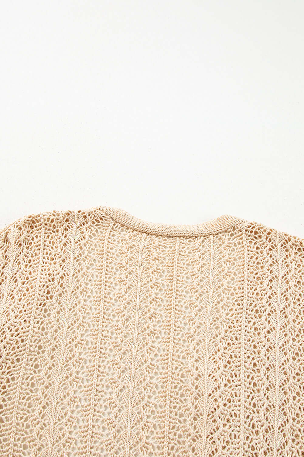 Back view of apricot beige Café Date Cardigan showcasing intricate cable knit and hollow-out details.
