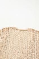 Back view of apricot beige Café Date Cardigan showcasing intricate cable knit and hollow-out details.