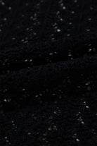 Close-up of black cable knit fabric featuring hollow-out details for the Café Date Cardigan.