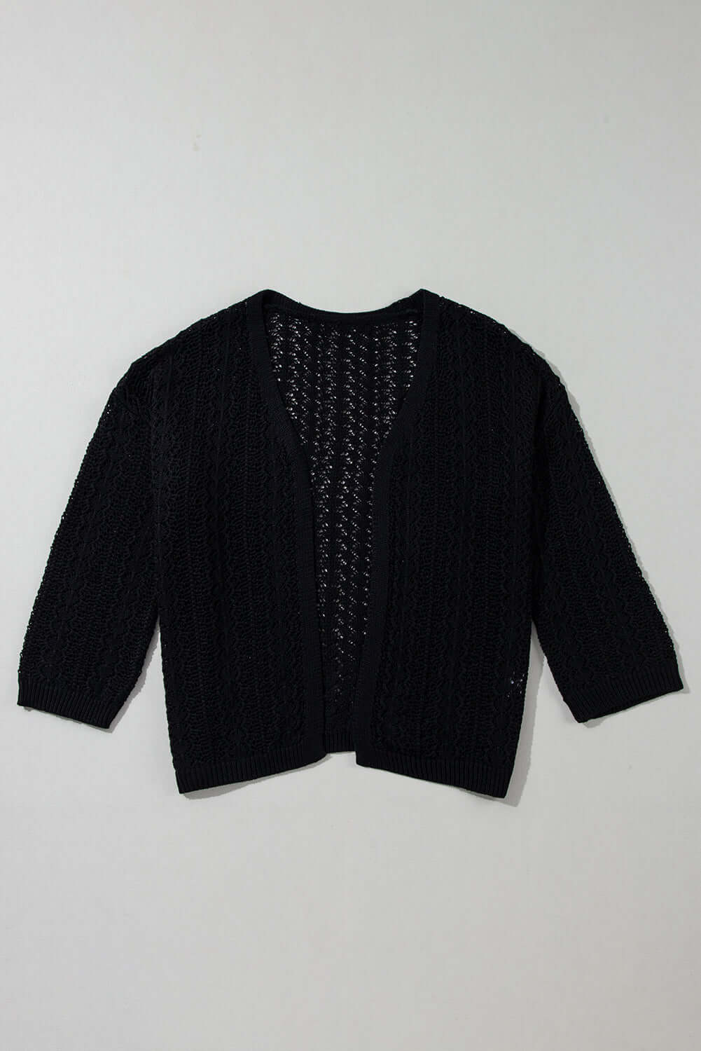 Café Date Cardigan in jet black, featuring cable knit and hollow-out details for a chic, cozy layering piece.