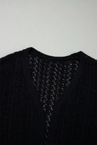 Jet black Café Date Cardigan showing solid cable knit and hollow-out details for a stylish layering essential.