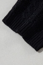 Close-up of the cable knit texture of the jet black Café Date Cardigan, highlighting its cozy design.
