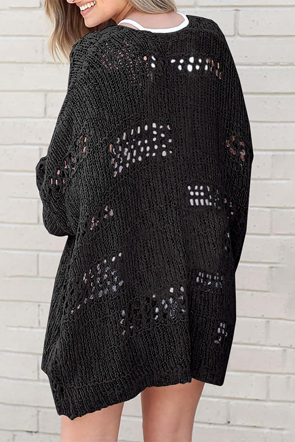 Back view of the Blackout Bliss Cardigan showcasing its open cable-knit design and relaxed fit.