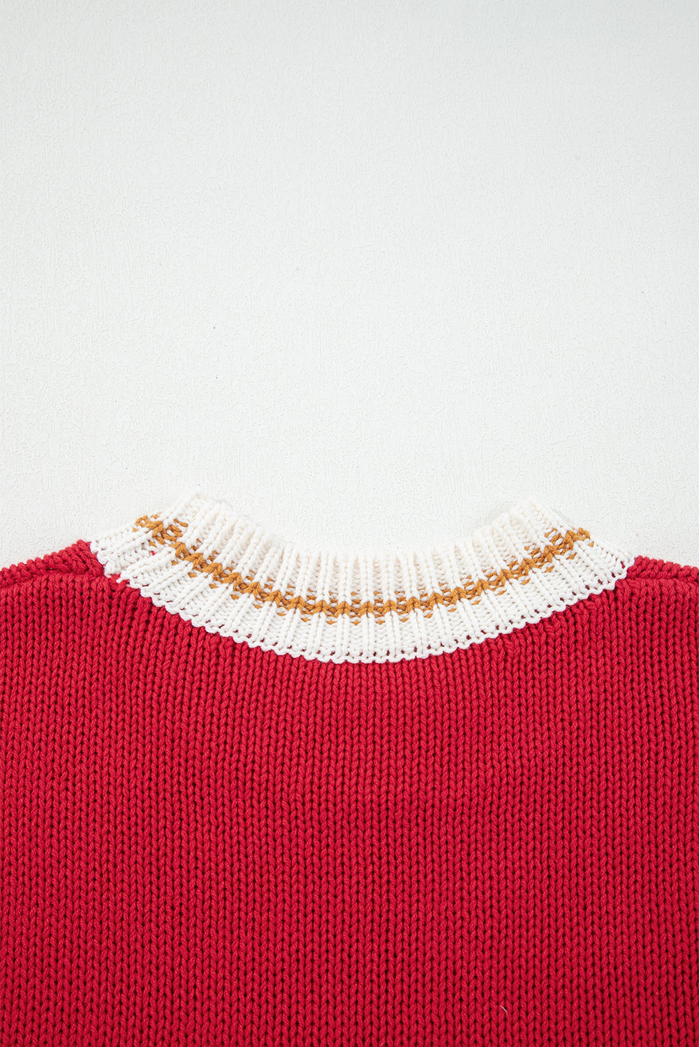 MERRY MOMENTS SWEATER with a cozy fiery red knit and festive white and gold ribbed neckline for the holiday season.