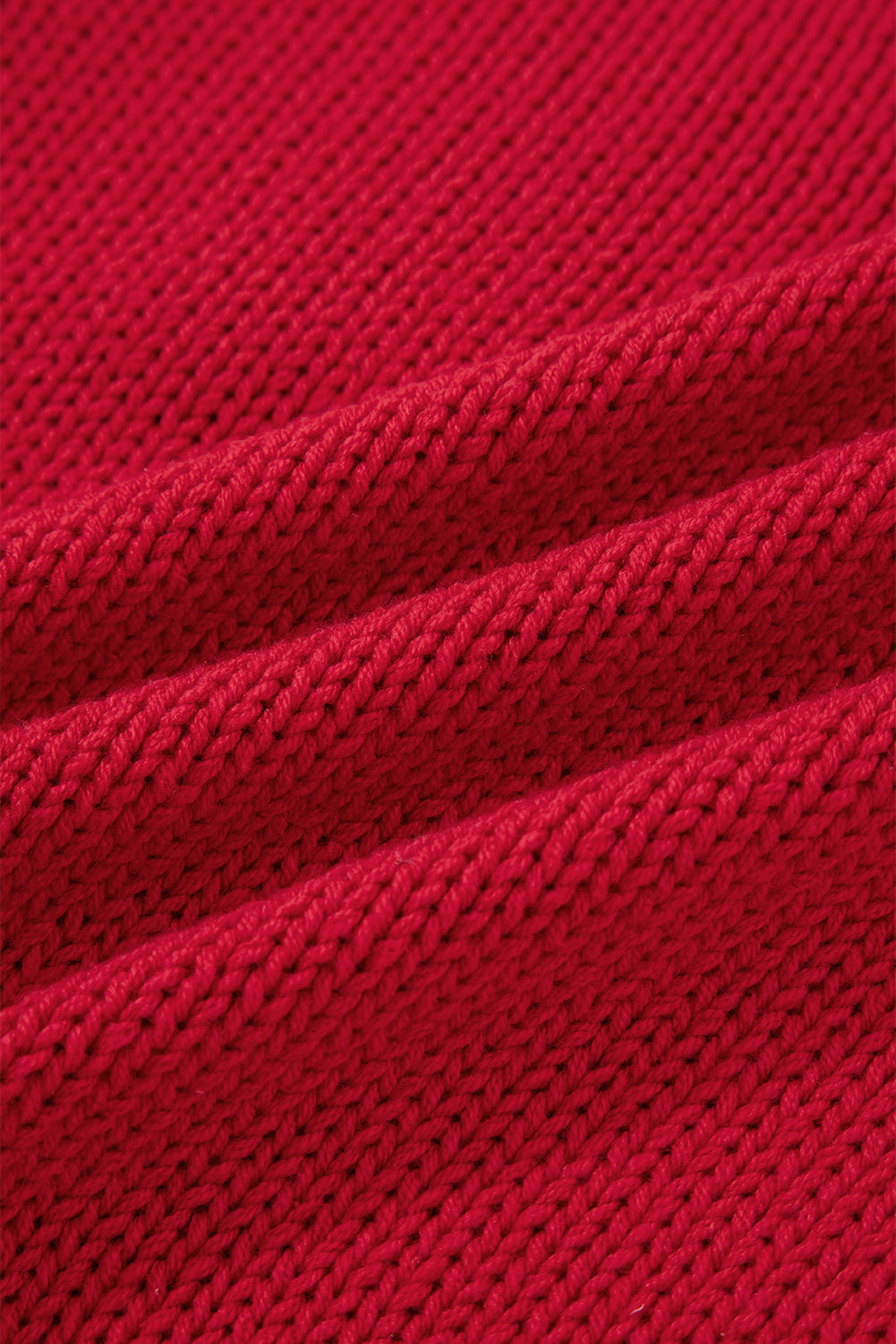 Textured close-up of the cozy Fiery Red fabric used in the MERRY MOMENTS SWEATER.