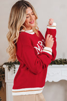 Model wearing MERRY MOMENTS SWEATER in red with drop shoulder style and festive graphic, perfect for holiday celebrations.