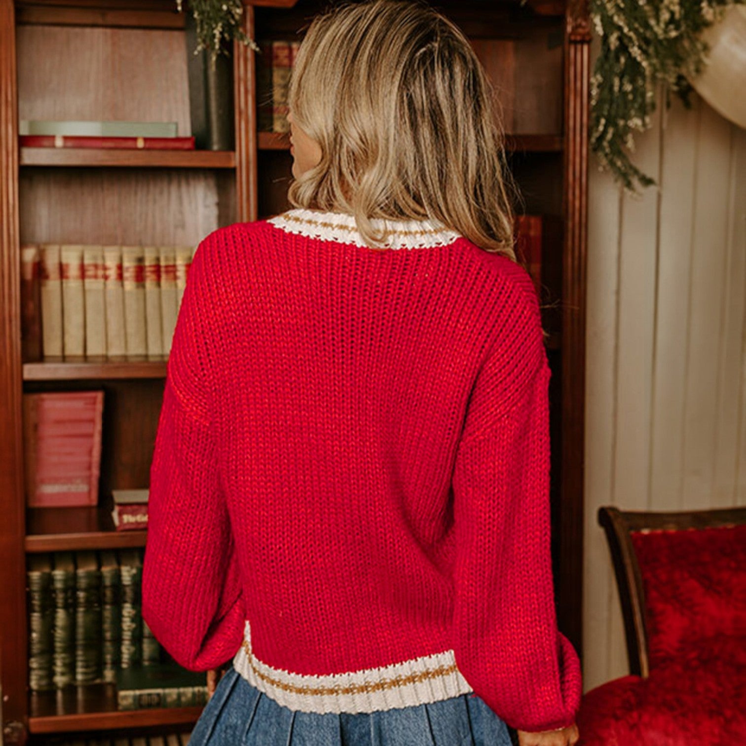 Back view of the MERRY MOMENTS SWEATER in vibrant red with a stylish drop shoulder fit and color block trim.