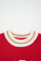 Close-up of the collar on the MERRY MOMENTS SWEATER featuring a vibrant red knit with a decorative gold and white trim.