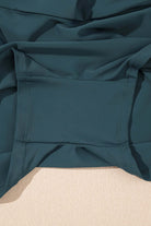 Close-up of the sea green fabric of the SeaGlass Serve Skort with a pocket detail.
