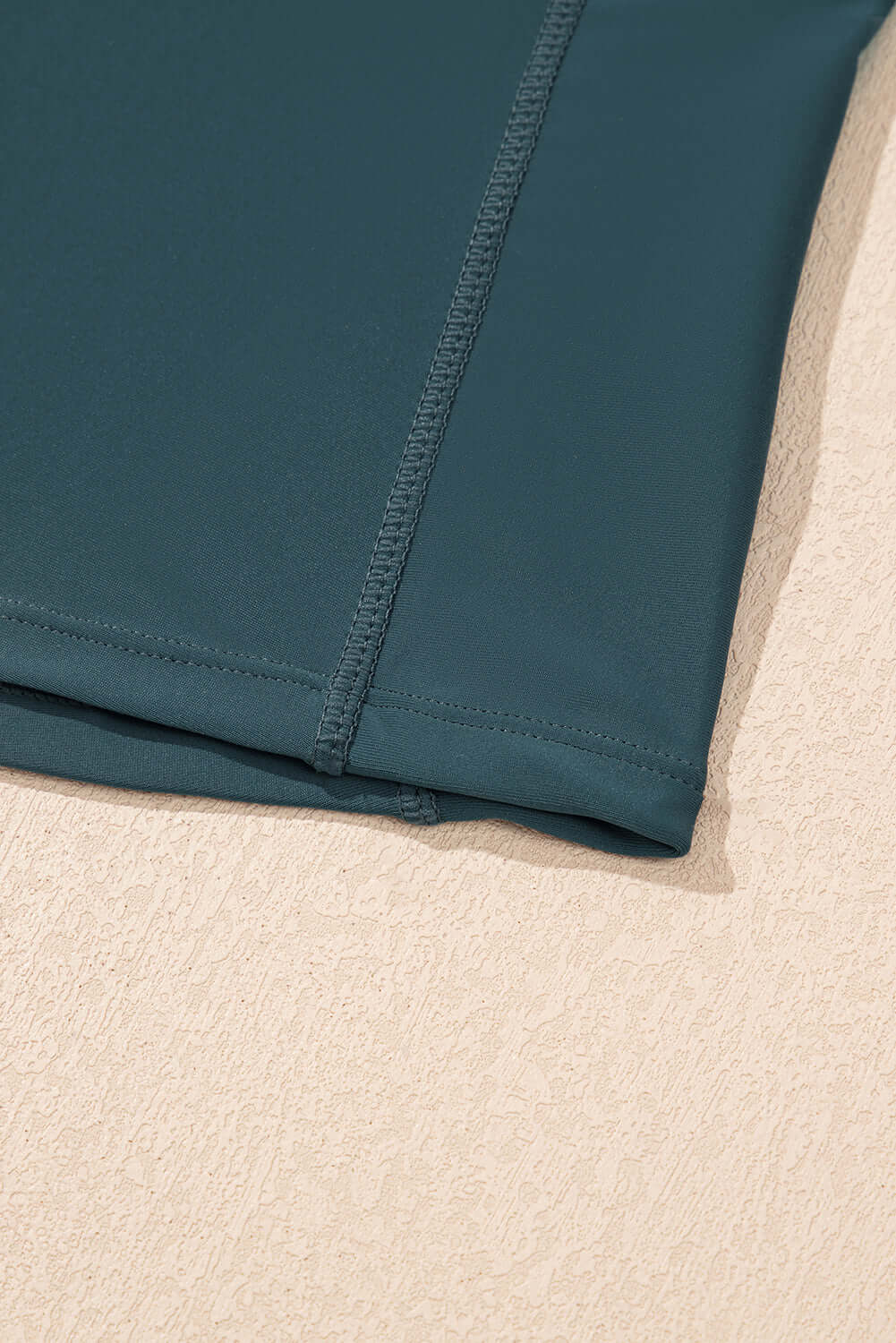 Close-up of the SeaGlass Serve Skort hem showcasing the sea green fabric and fine stitching details.