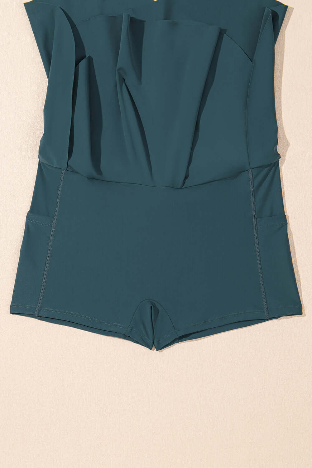 SeaGlass Serve Skort in sea green with crossover V-waist and side pockets for swim activities.