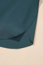 Detail of SeaGlass Serve Skort showcasing the smooth sea green fabric and stylish crossover design.