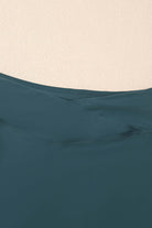 Close-up of SeaGlass Serve Skort crossover V-waist in sea green fabric, highlighting design and smooth finish.