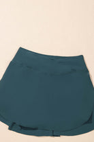 SeaGlass Serve Skort in sea green, high-waisted swim skort with crossover V-waist design and side pockets.