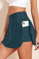 SeaGlass serve skort in sea green with side pocket for phone, showcasing sporty-chic and flattering design.