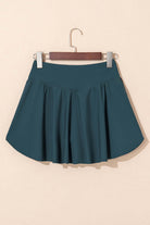 SeaGlass Serve Skort in sea green, featuring a crossover V-waist and A-line design for stylish comfort.