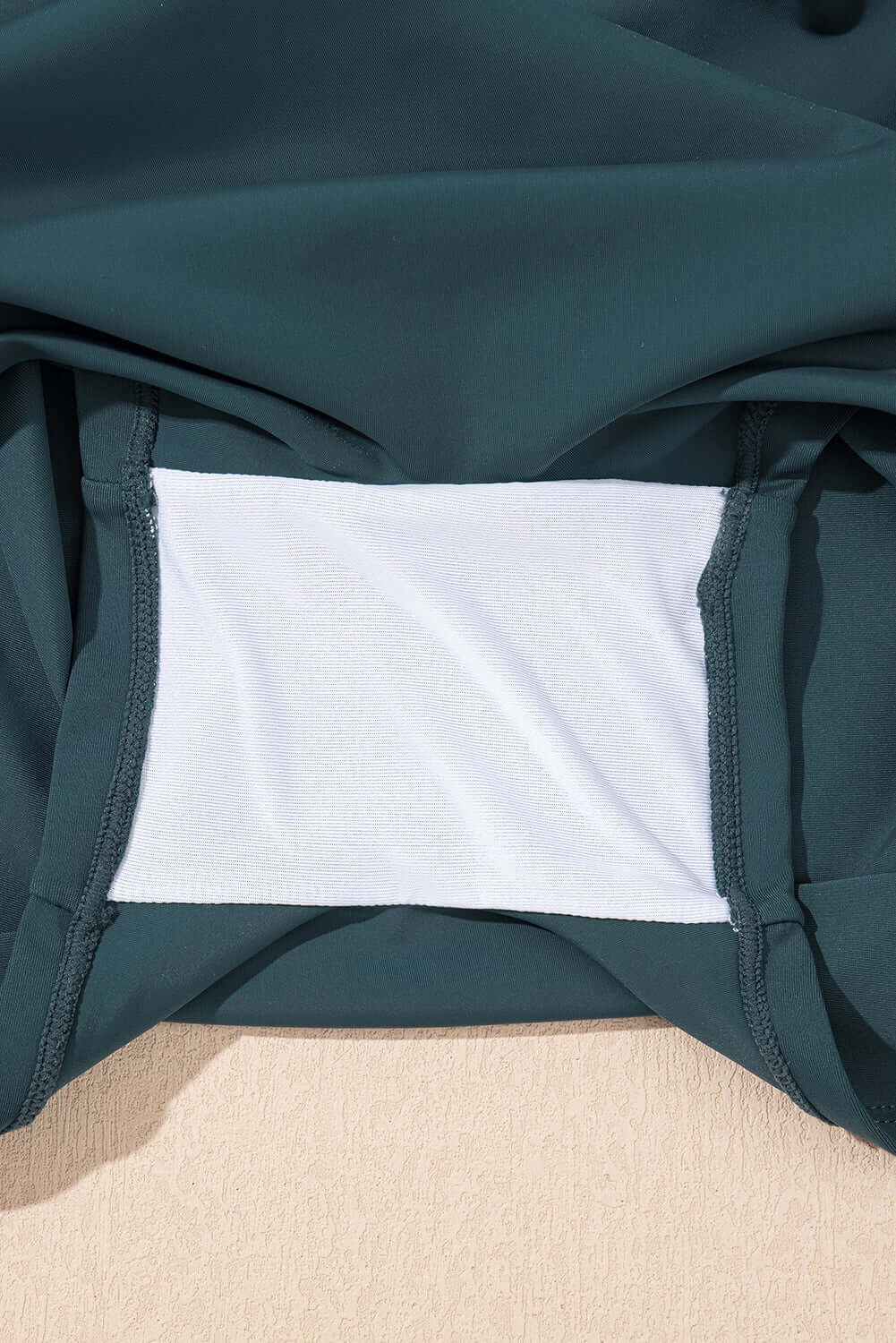 Close-up of the inner lining of a sea green skort, showcasing its soft material and stitching details.