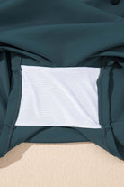Close-up of the inner lining of a sea green skort, showcasing its soft material and stitching details.