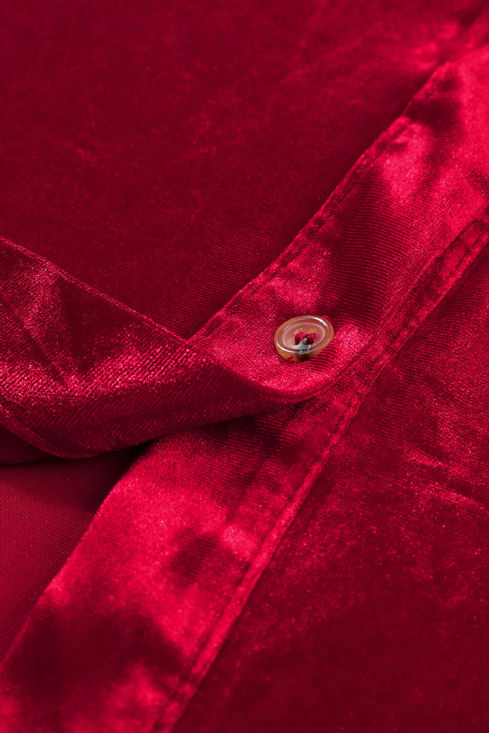 Close-up of vibrant red berry velvet dress fabric with button detail, featuring a textured and sophisticated look by Vivian-Lu.