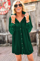 Vibrant evergreen velvet dress with collared neck and buttons, worn by model outdoors, showcasing style and elegance.