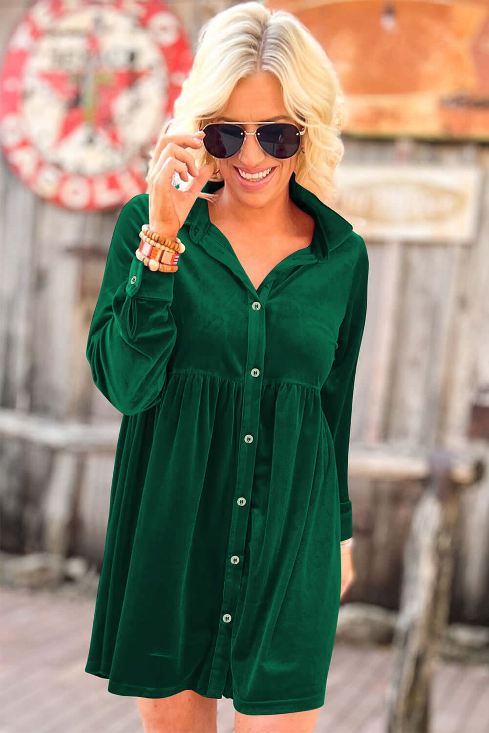 Woman in evergreen velvet dress with front buttons and collared neck by Vivian-Lu, showcasing a stylish and relaxed fit.