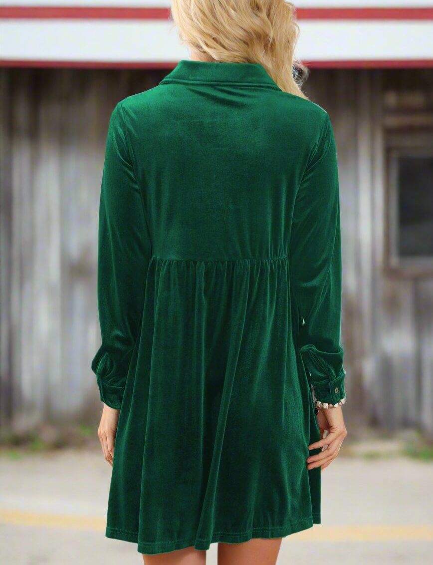 Woman wearing a vibrant velvet dress in evergreen with a collared neck and relaxed fit, showcasing elegant back view for style and comfort.