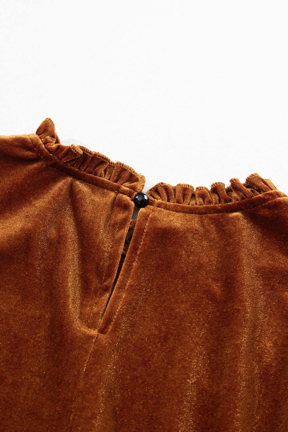 Close-up of the chestnut brown velvet fabric with a keyhole button closure on the CHESTNUT CHEER Dress by Vivian-Lu.