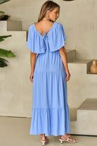 Back view of Dreamfield Days Maxi Dress in sky blue, featuring flutter sleeves and a tied neckline.