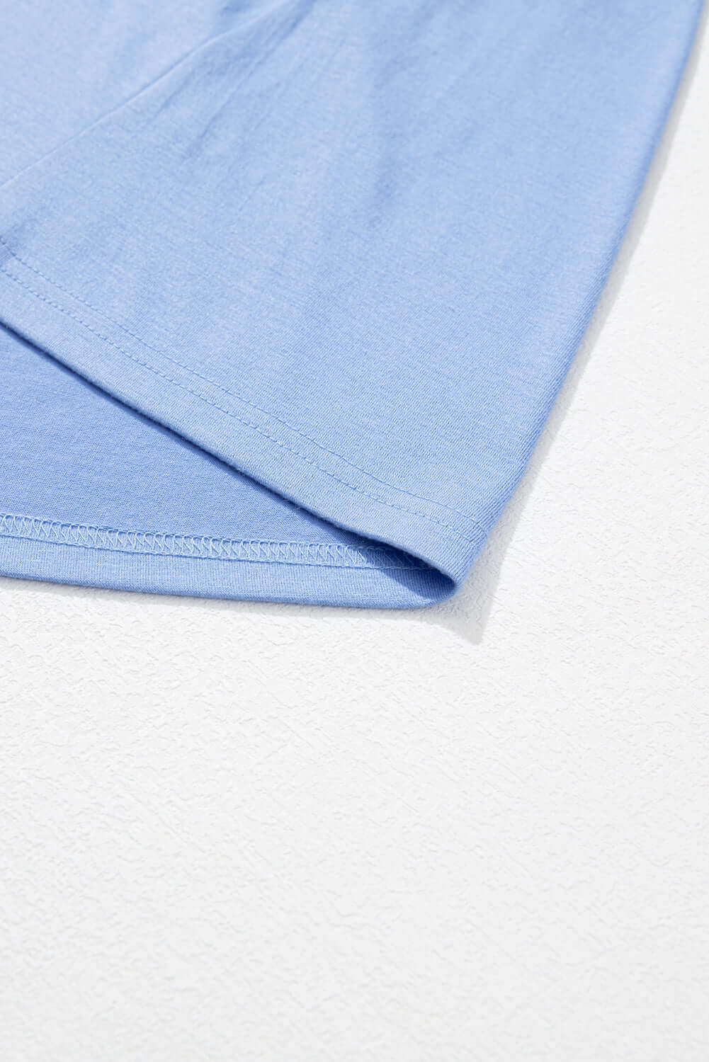 Close-up of the soft sky blue fabric of the DREAMFIELD DAYS Maxi Dress, showcasing its elegant drape and quality material.
