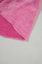 Strawberry pink mineral wash fabric of Sweetwater Serenade dress with crinkle texture and raw edge hem.